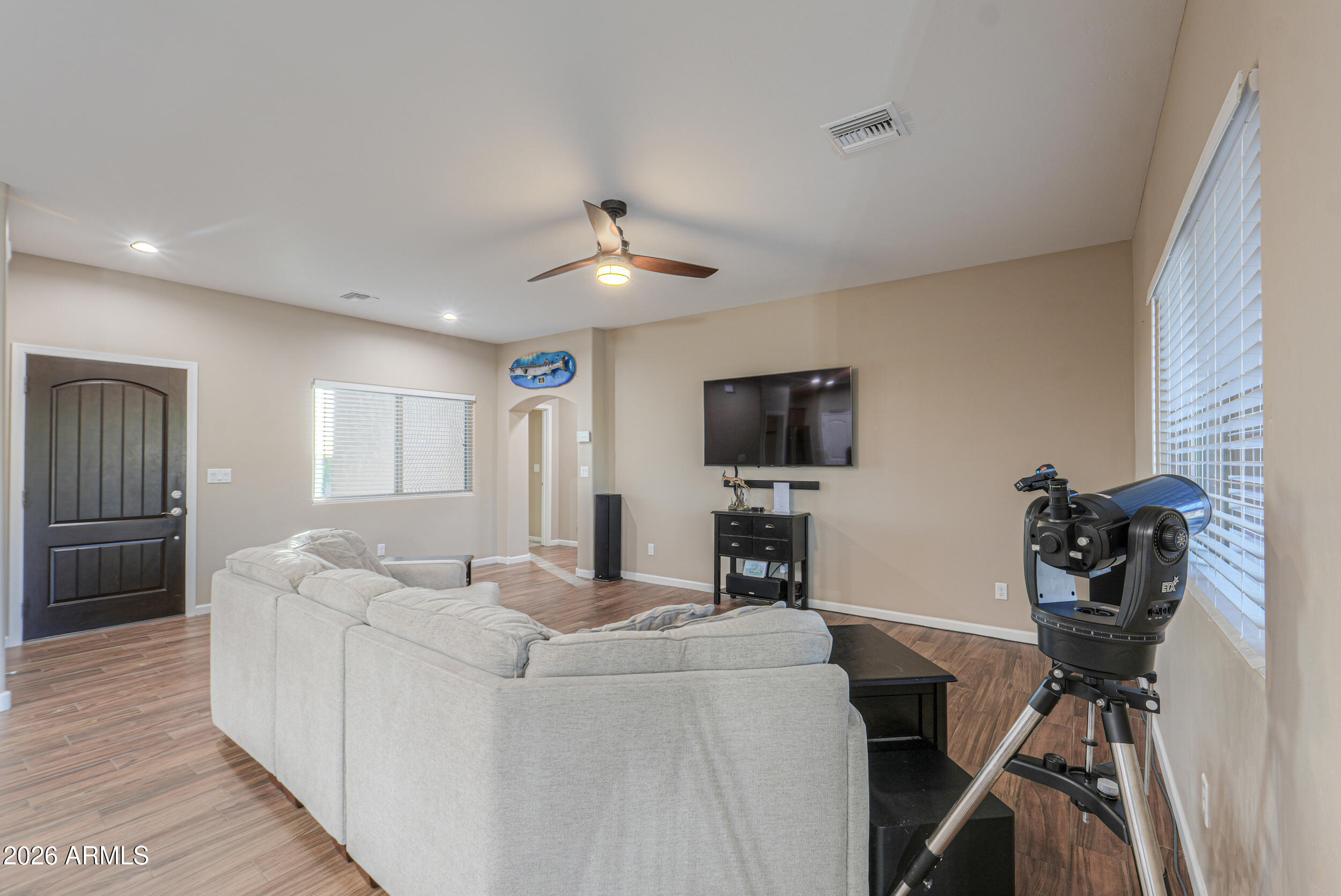 1487 South Mountain View Road Apache Junction, AZ 85119 - Photo 11 of 60 a living room with furniture and a flat screen tv