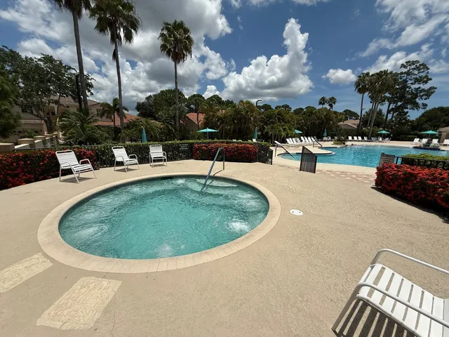 a view of a swimming pool with outdoor seating