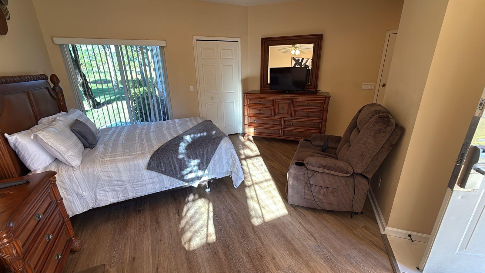 8294 Mulligan Circle, Unit B Port St. Lucie, FL 34986 - Photo 3 of 15 a living room with furniture and wooden floor