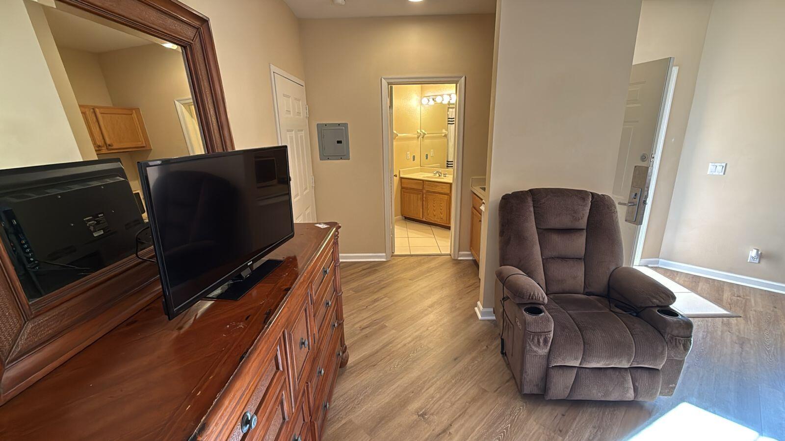 8294 Mulligan Circle, Unit B Port St. Lucie, FL 34986 - Photo 4 of 15 a living room with furniture and a flat screen tv