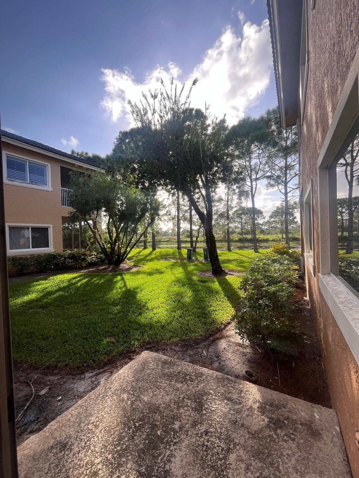 8294 Mulligan Circle, Unit B Port St. Lucie, FL 34986 - Photo 7 of 15 a view of a yard with a slide