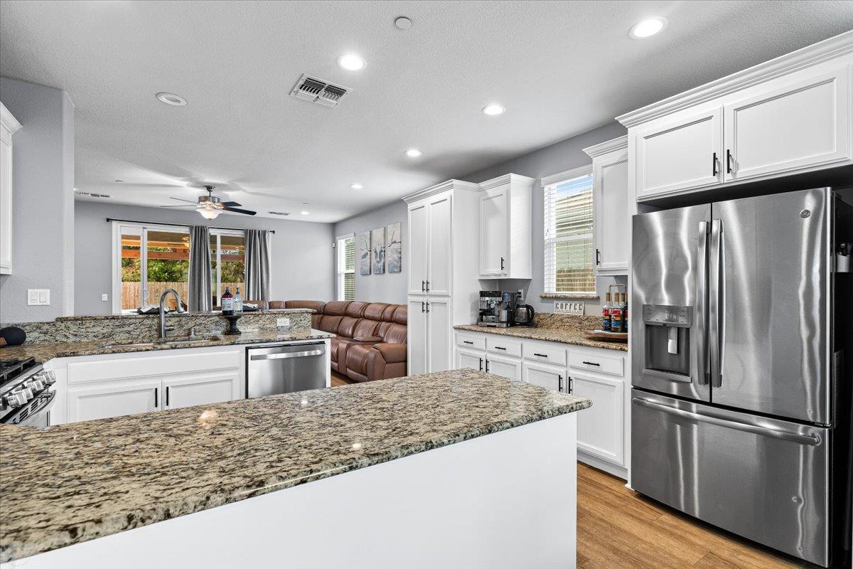 6617 Cervi Road Riverbank, CA 95367 - Photo 11 of 51 a kitchen with stainless steel appliances granite countertop a refrigerator oven stove sink and cabinets