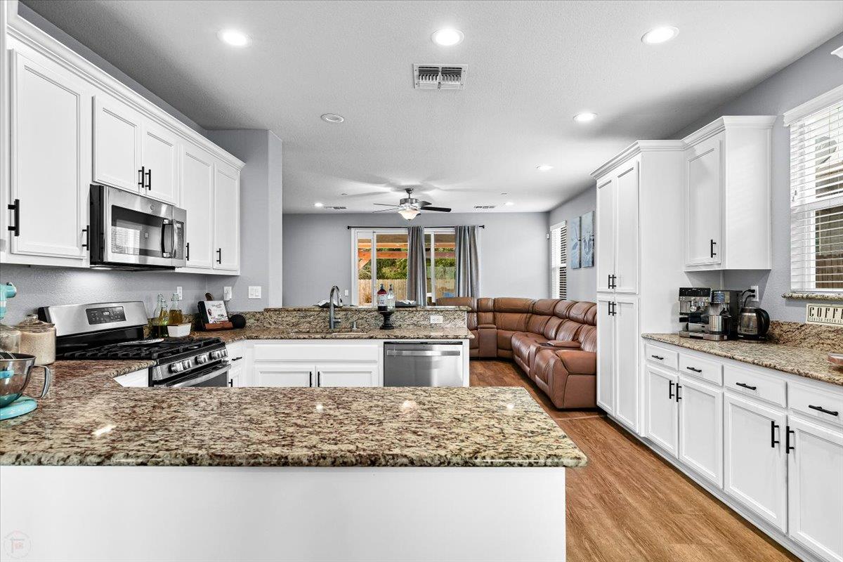 6617 Cervi Road Riverbank, CA 95367 - Photo 12 of 51 a kitchen with stainless steel appliances granite countertop a stove sink and cabinets