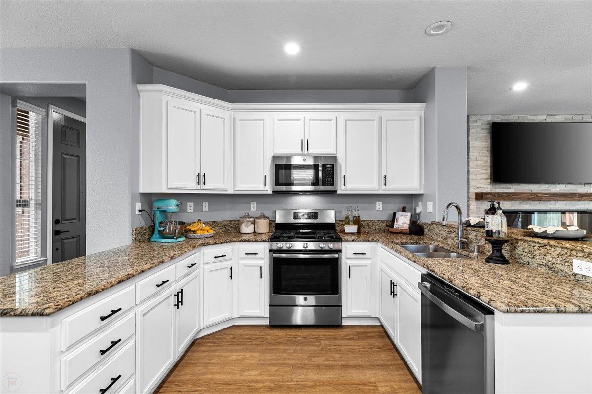 6617 Cervi Road Riverbank, CA 95367 - Photo 14 of 51 a kitchen with granite countertop a stove sink and cabinets