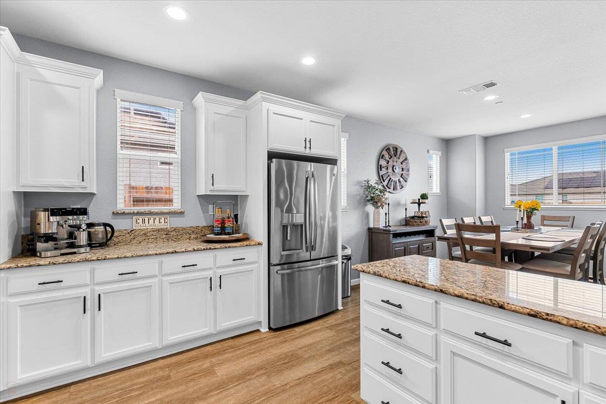 6617 Cervi Road Riverbank, CA 95367 - Photo 16 of 51 a kitchen with granite countertop a refrigerator and wooden cabinets