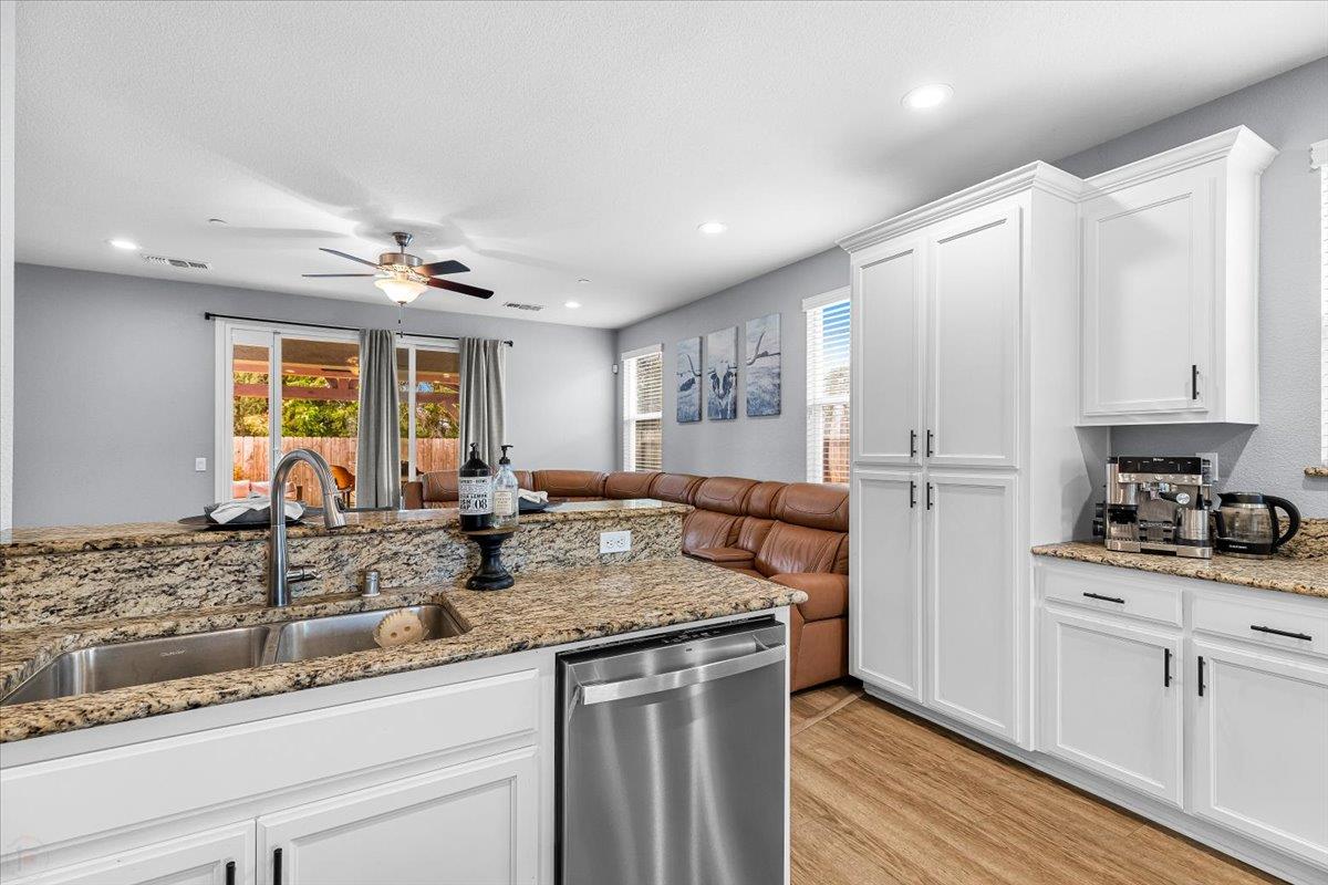 6617 Cervi Road Riverbank, CA 95367 - Photo 17 of 51 a kitchen with stainless steel appliances granite countertop a sink stove and cabinets