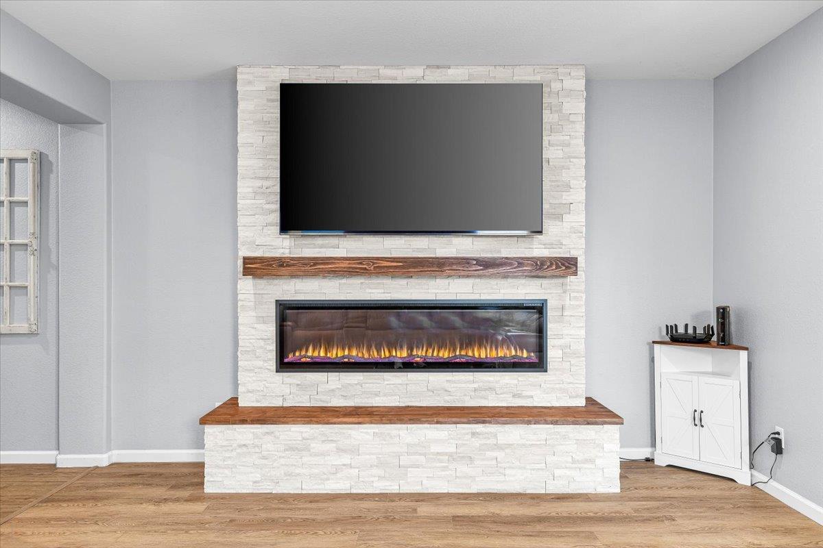 6617 Cervi Road Riverbank, CA 95367 - Photo 23 of 51 a living room with a fireplace and wooden floor