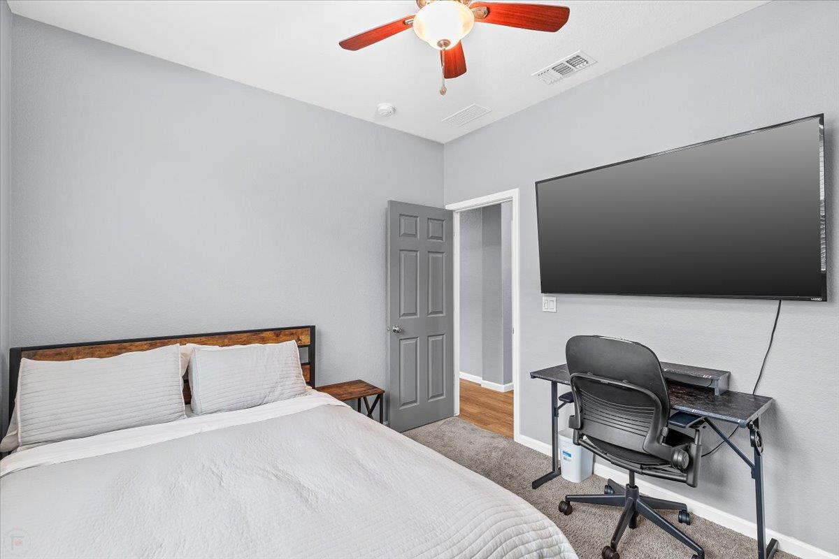 6617 Cervi Road Riverbank, CA 95367 - Photo 27 of 51 a bedroom with a bed and a chair