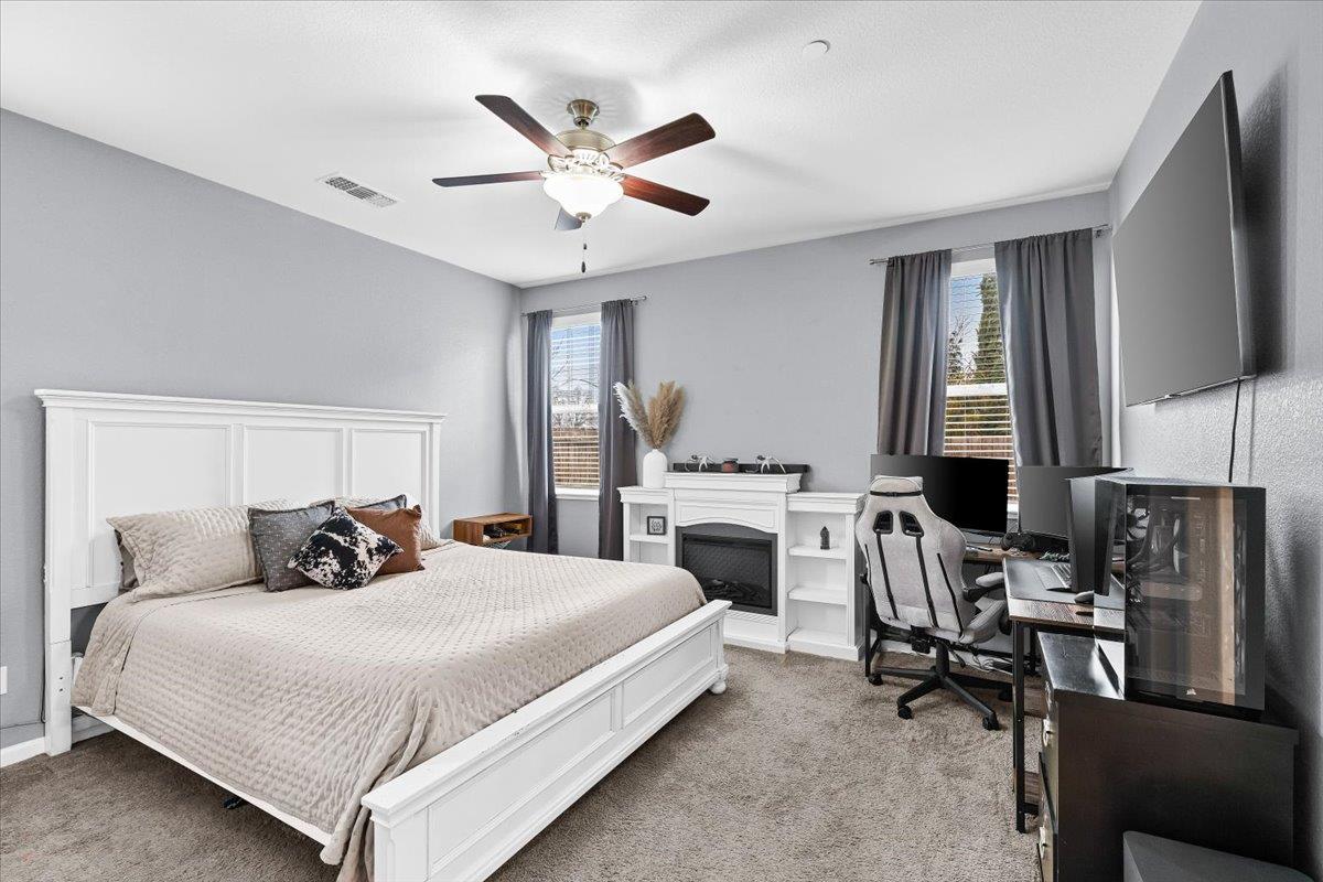 6617 Cervi Road Riverbank, CA 95367 - Photo 31 of 51 a bedroom with a large bed and a flat screen tv