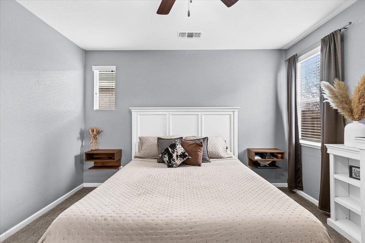 6617 Cervi Road Riverbank, CA 95367 - Photo 32 of 51 a bedroom with a bed and a lamp