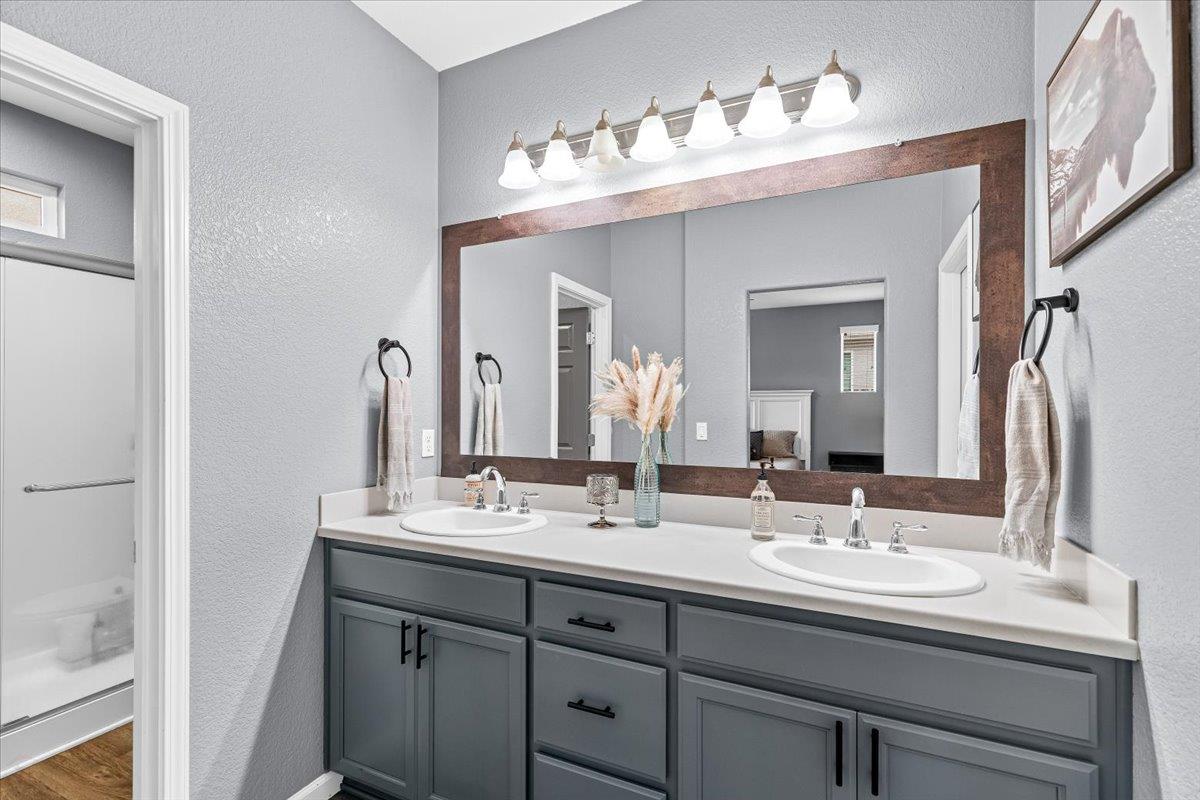 6617 Cervi Road Riverbank, CA 95367 - Photo 34 of 51 a bathroom with double vanity sinks and a mirror