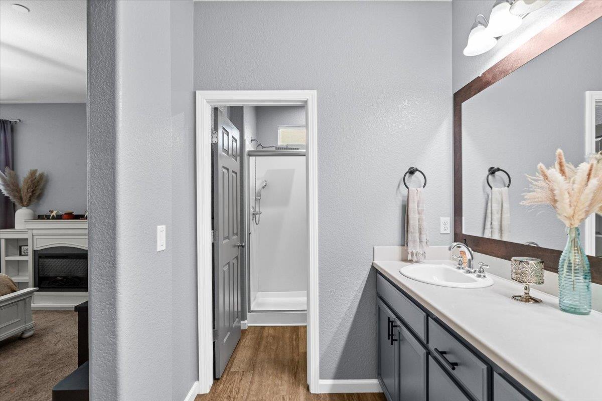 6617 Cervi Road Riverbank, CA 95367 - Photo 35 of 51 a en suite bathroom with a double vanity sink and a mirror