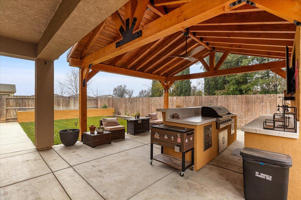 6617 Cervi Road Riverbank, CA 95367 - Photo 39 of 51 a roof deck with table and chairs under an umbrella