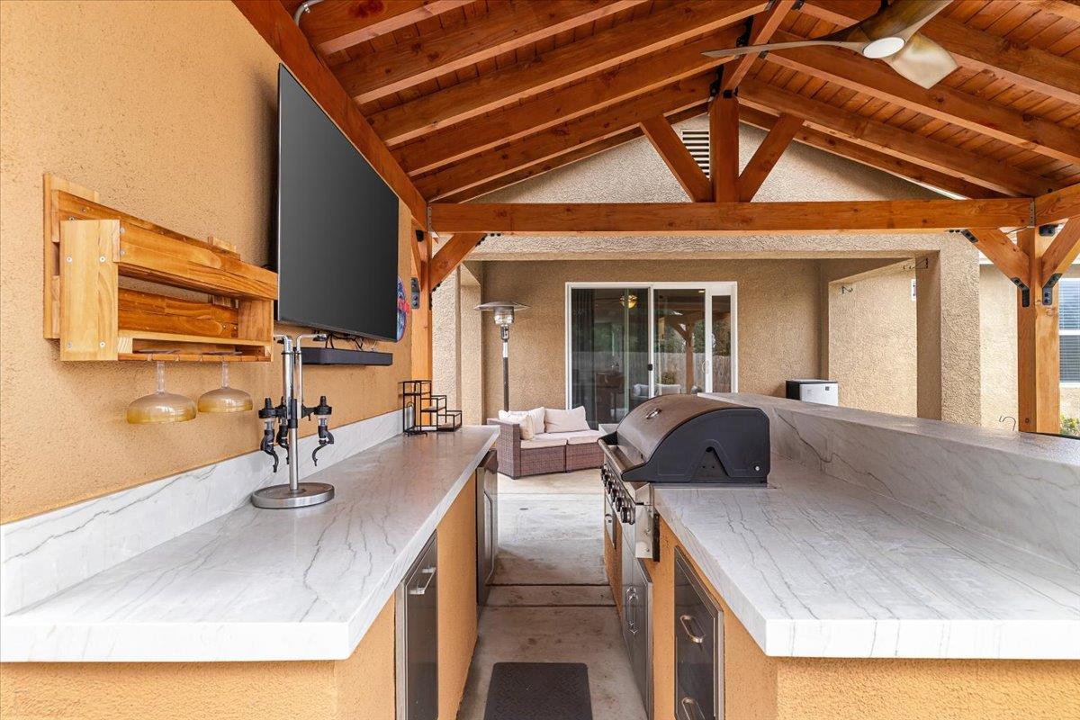 6617 Cervi Road Riverbank, CA 95367 - Photo 42 of 51 a kitchen with granite countertop a sink and a refrigerator
