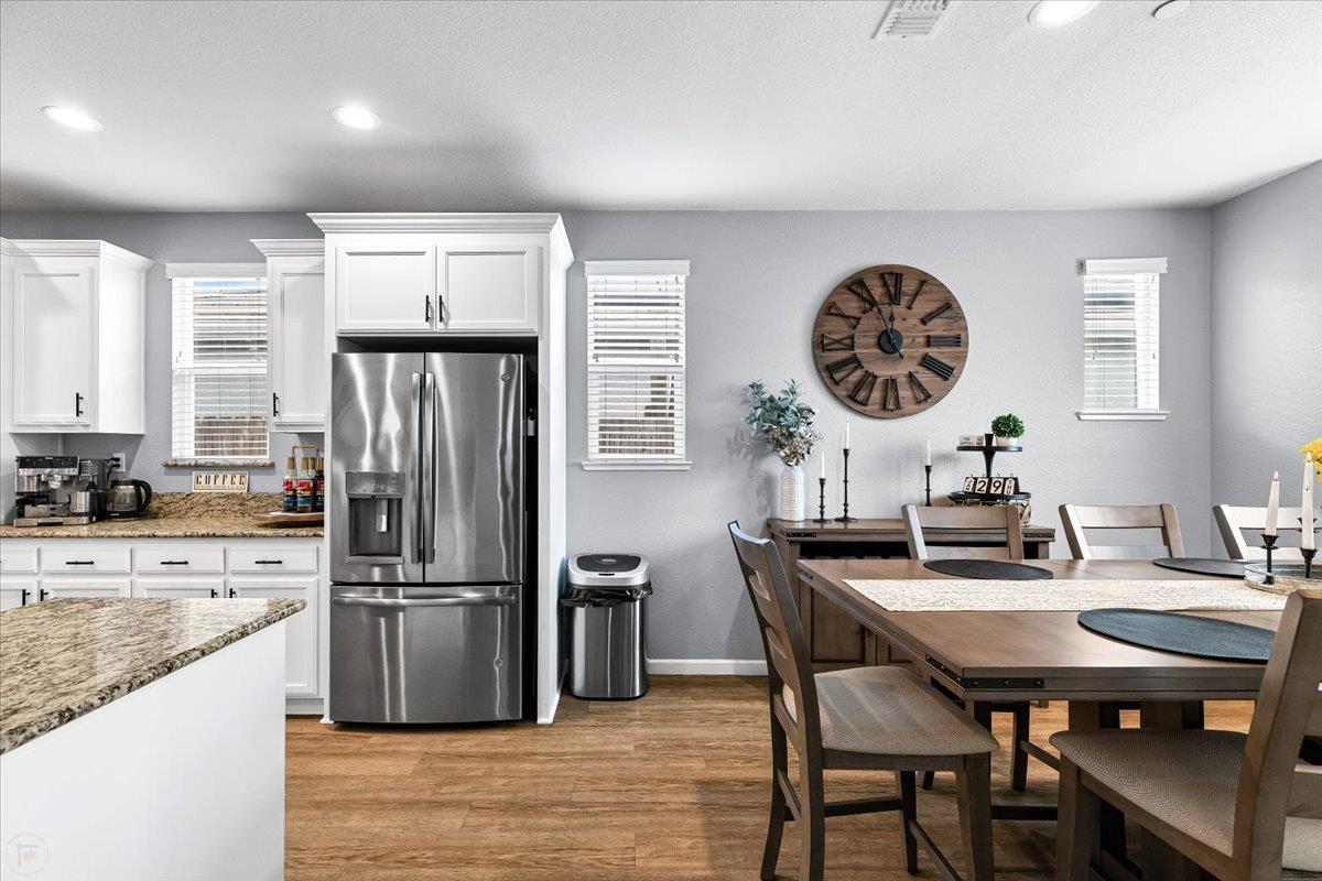 6617 Cervi Road Riverbank, CA 95367 - Photo 7 of 51 a kitchen with a table chairs and a refrigerator