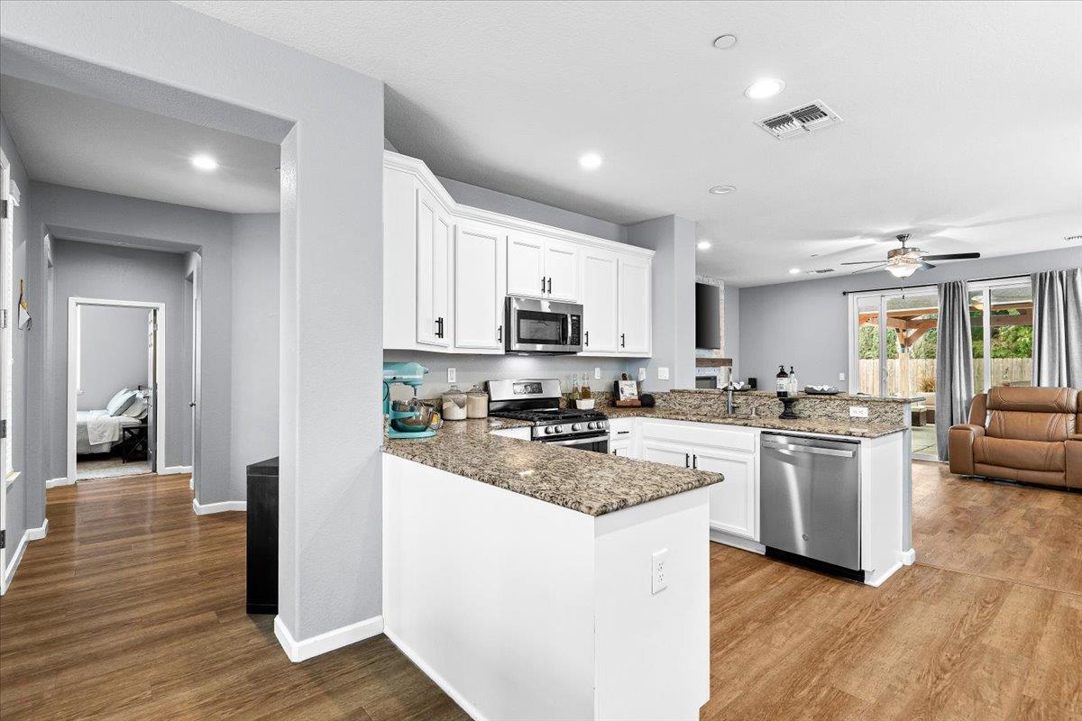 6617 Cervi Road Riverbank, CA 95367 - Photo 10 of 51 a kitchen with stove a sink and a refrigerator