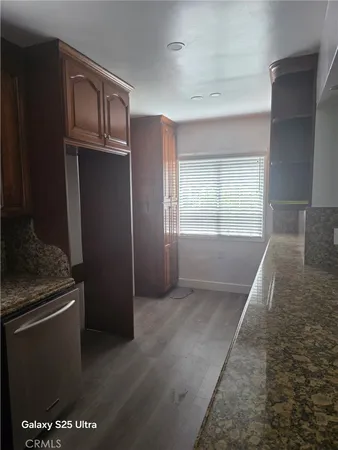 a view of a kitchen with an empty space and a window