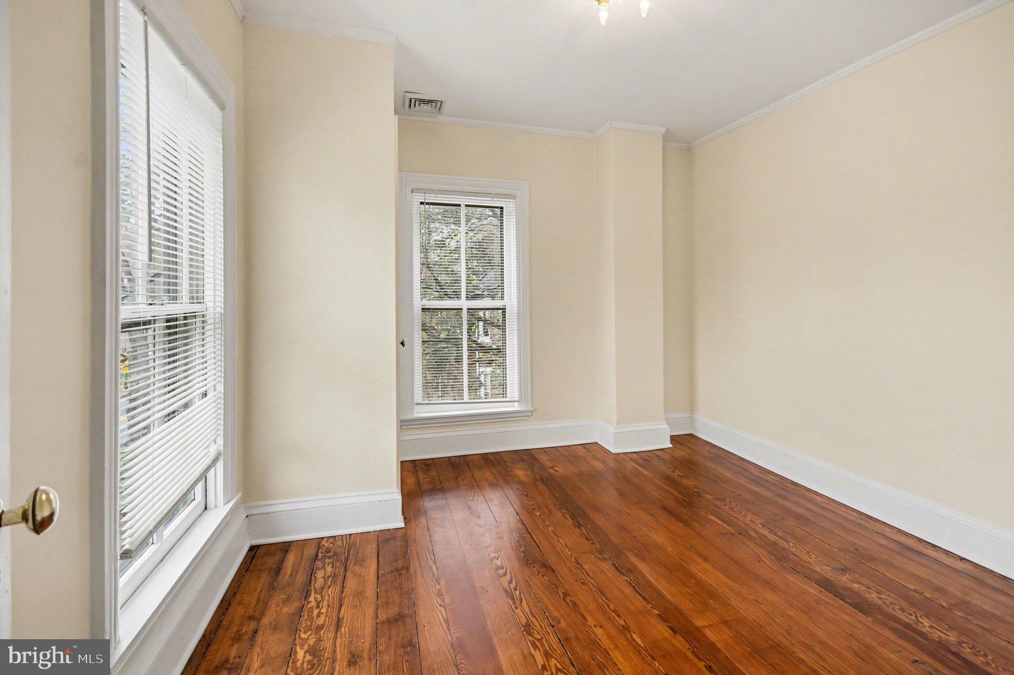 9627 Easton Road Upper Black Eddy, PA 18972 - Photo 11 of 28 an empty room with wooden floor and windows