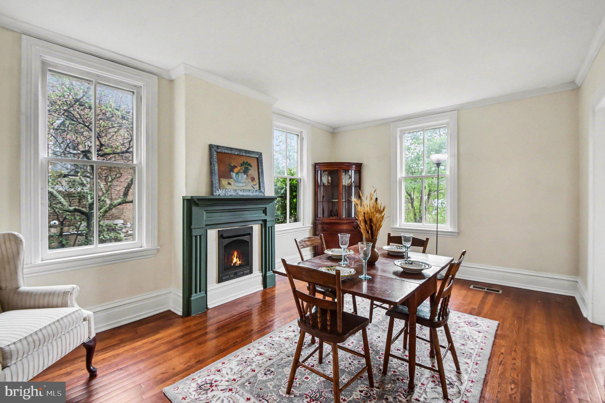 9627 Easton Road Upper Black Eddy, PA 18972 - Photo 16 of 28 a dining room with furniture a fireplace and wooden floor