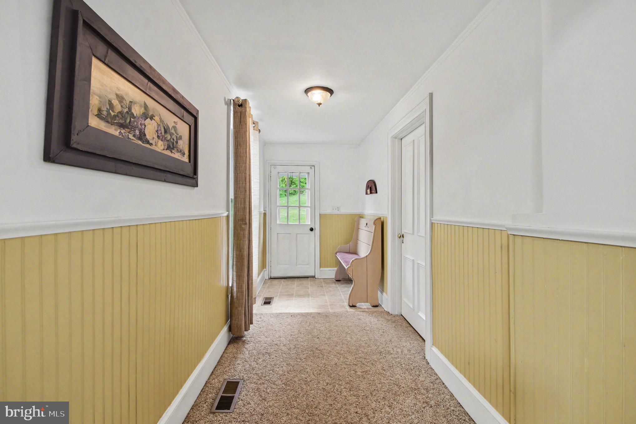 9627 Easton Road Upper Black Eddy, PA 18972 - Photo 17 of 28 a view of a hallway with wooden floor and a refrigerator