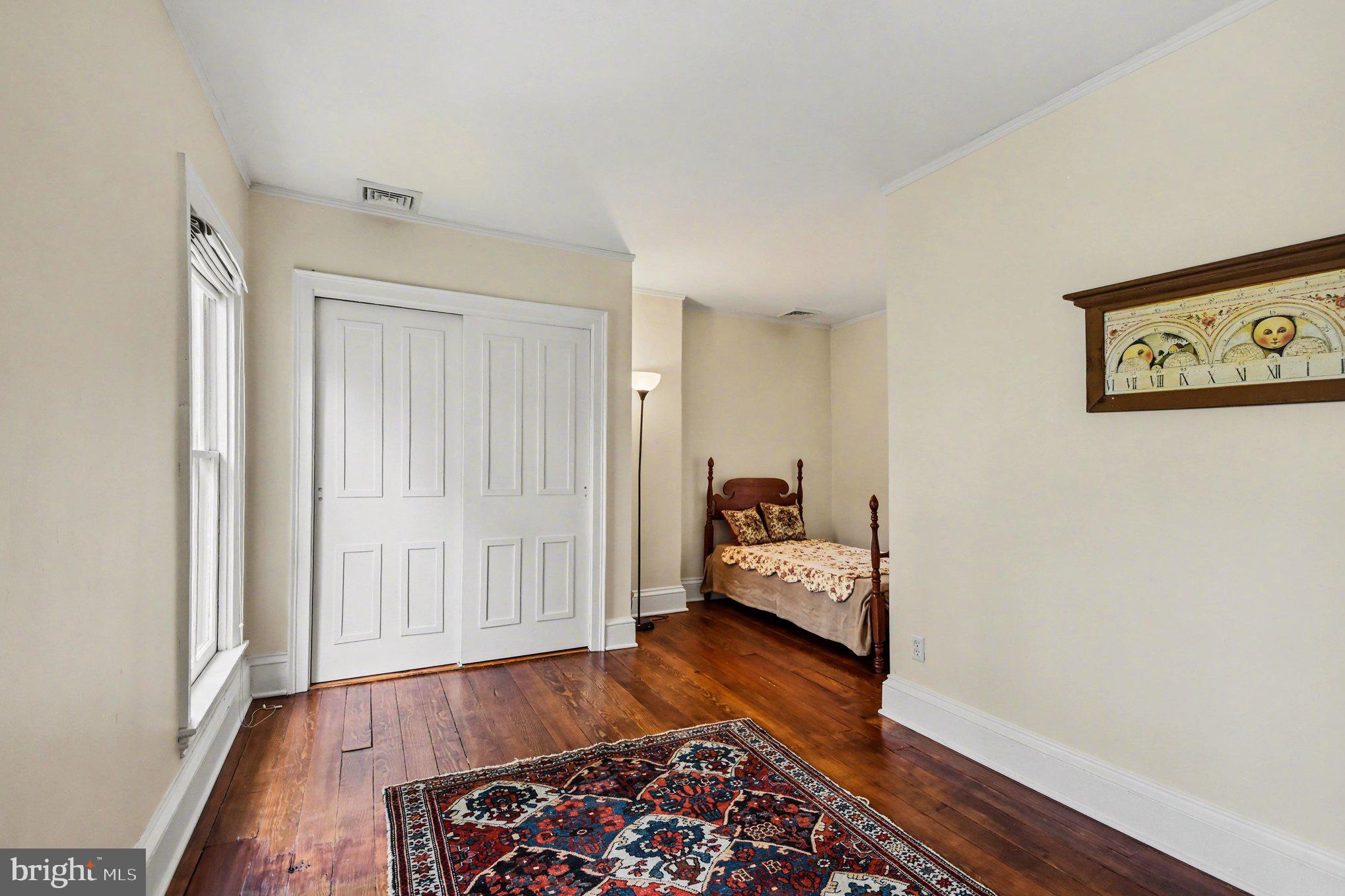 9627 Easton Road Upper Black Eddy, PA 18972 - Photo 22 of 28 a bed room with furniture and wooden floor