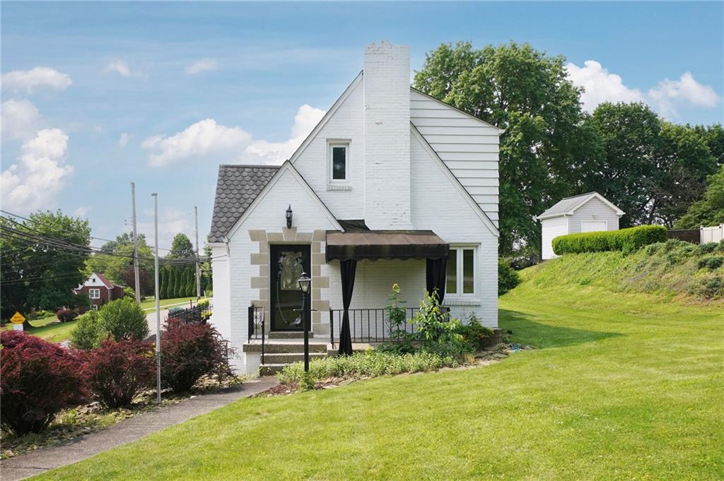 a front view of house with garden