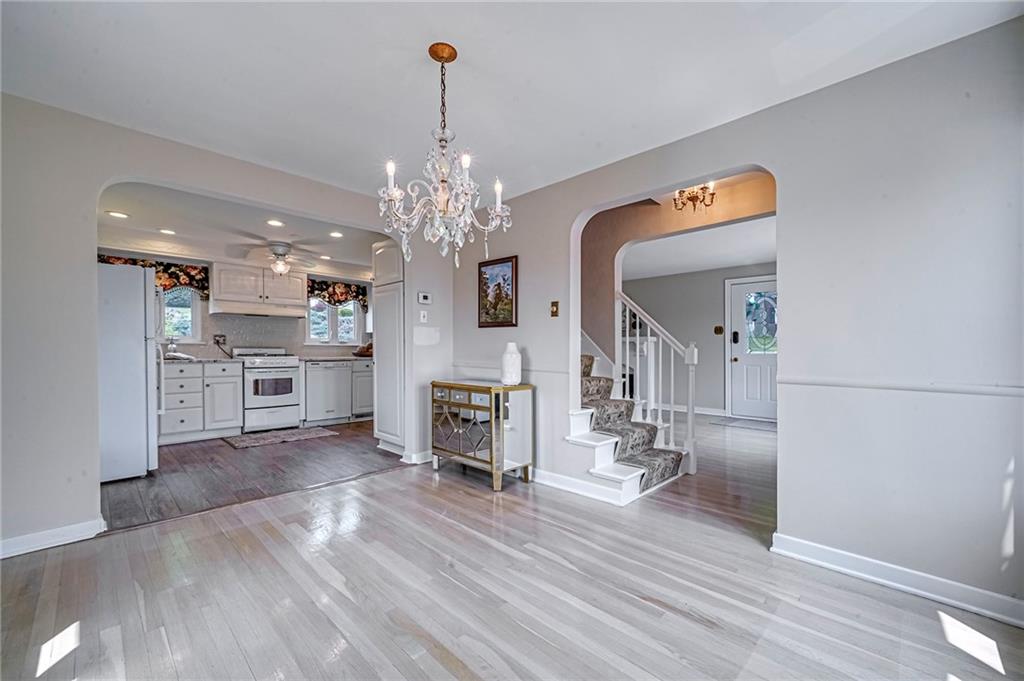 12 Kennedy Lane McKees Rocks, PA 15136 - Photo 15 of 29 a view of a hallway with wooden floor and chandelier