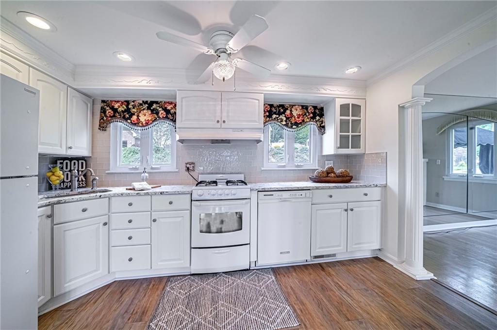 12 Kennedy Lane McKees Rocks, PA 15136 - Photo 7 of 29 a kitchen with stainless steel appliances granite countertop a stove a sink and white cabinets