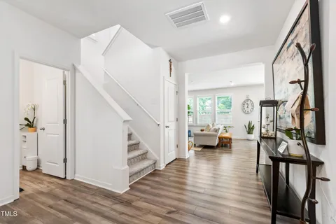 a front view of a house with a yard and potted plants