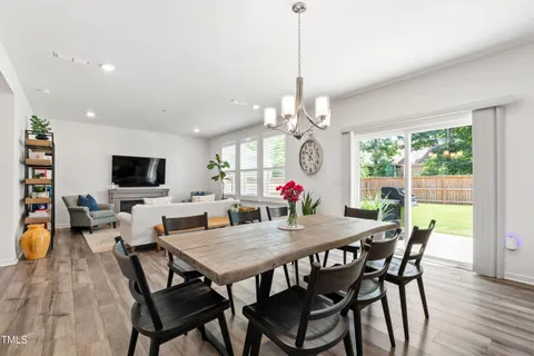a living room with furniture a flat screen tv and a potted plant