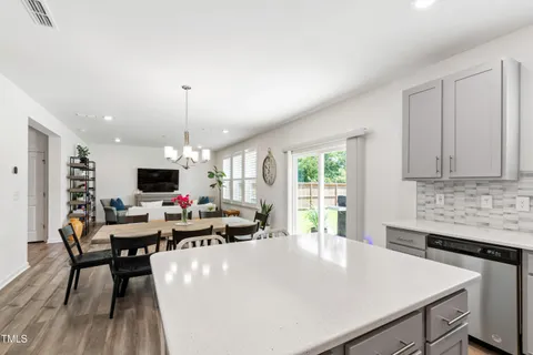 a kitchen that has a lot of cabinets a sink and a refrigerator
