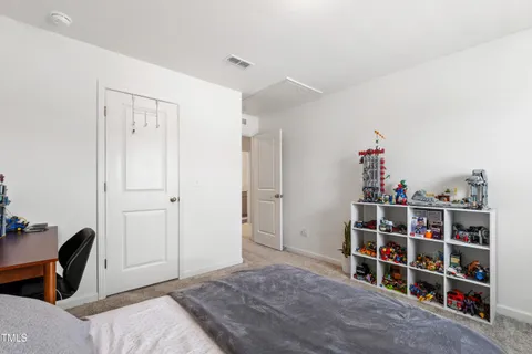 a bedroom with a bed and a bookshelf