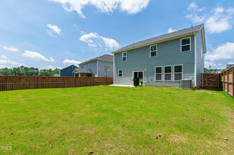 a view of a house with backyard and porch