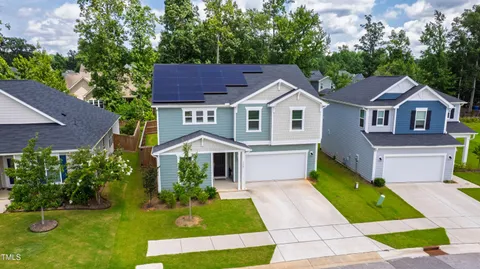 a front view of a house with a yard table and chairs