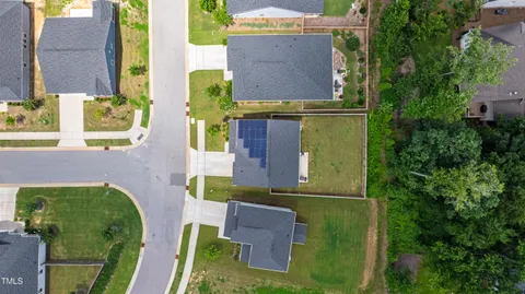 aerial view of multi story residential apartment building with yard