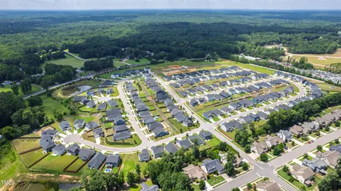 an aerial view of a house with a swimming pool yard and outdoor seating