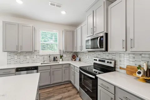 a living room with furniture and a book shelf