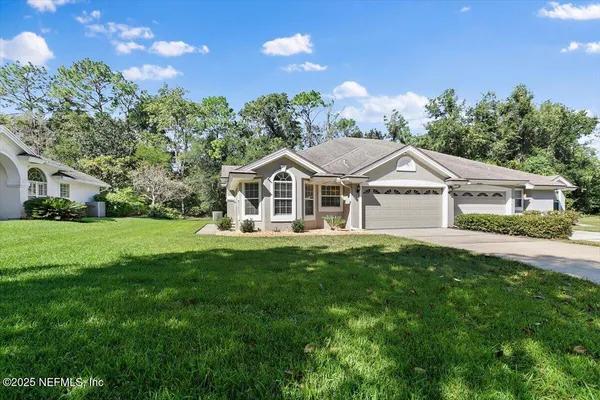 a aerial view of a house with yard and green space
