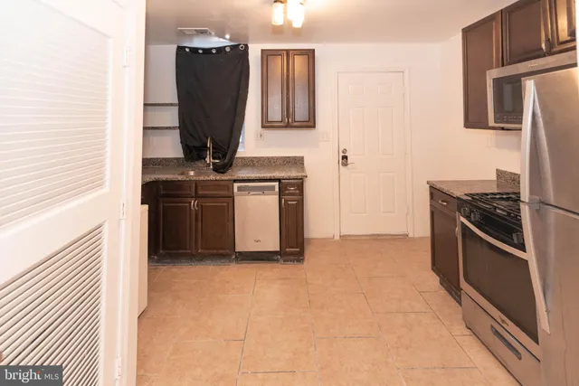 a kitchen with a refrigerator and a stove