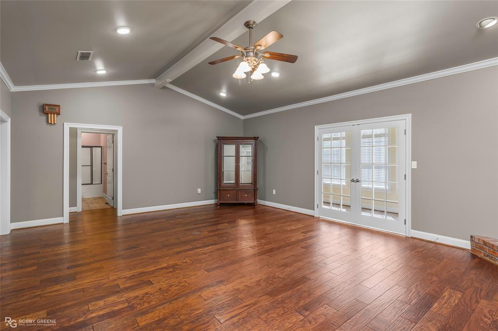 703 Airport Loop Homer, LA 71040 - Photo 5 of 32 a view of an empty room with wooden floor and a window