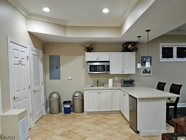 a kitchen with a sink refrigerator and cabinets