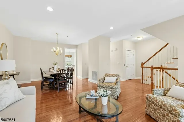 a living room with furniture and a dining table