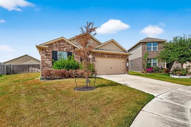 a front view of house with yard and trees around
