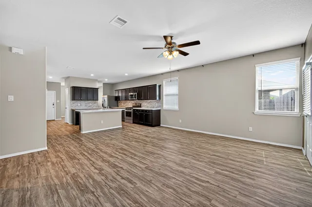 a view of a kitchen with a microwave and a stove top oven