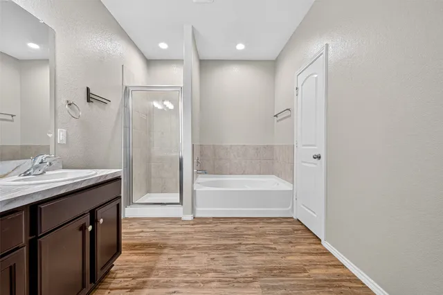 a bathroom with a granite countertop sink a toilet and shower