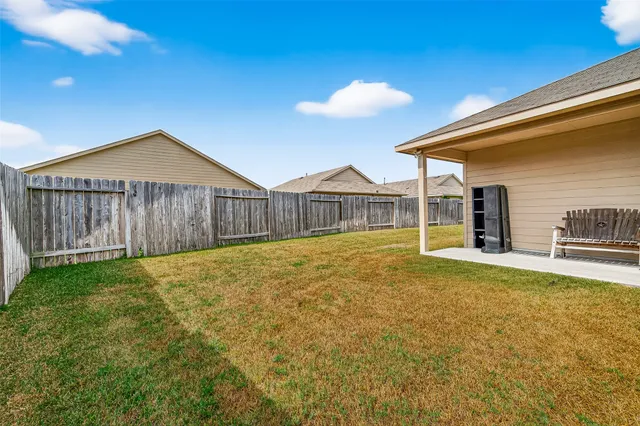 a view of a house with a backyard and a table