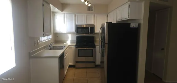 a kitchen with a refrigerator stove and sink