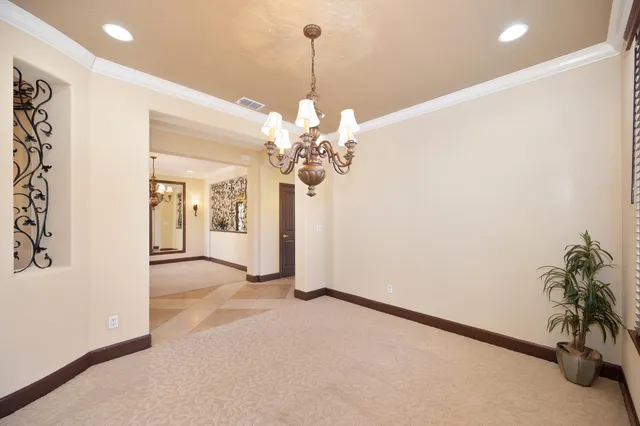 a view of a kitchen with granite countertop lots of counter top space a sink appliances and cabinets