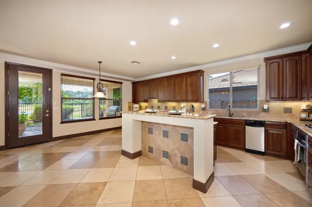 a view of an empty room with a fireplace and a large window