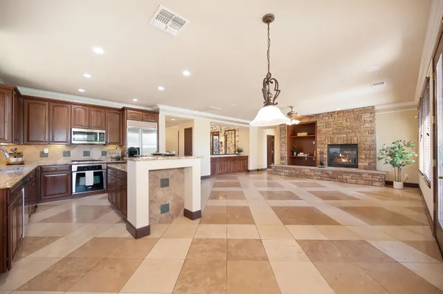 a view of a green field with a house in the background